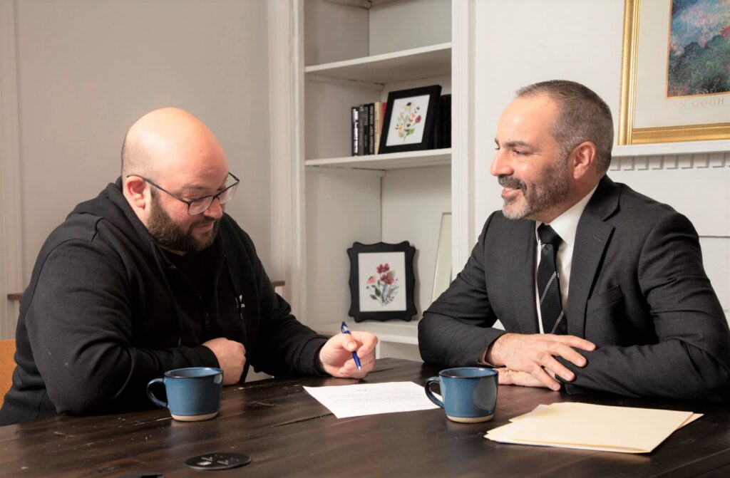 white plains personal injury attorney jeff weiskoph in suit with client in black clothes